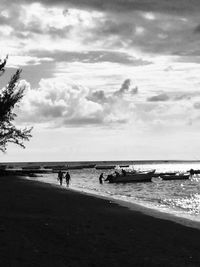 Scenic view of calm sea against cloudy sky