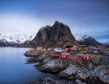 Scenic view of lake by mountains against sky