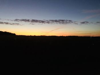 Silhouette landscape against sky during sunset