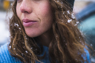 Woman face detail with snow in hair