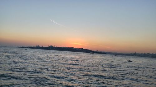 Scenic view of sea against clear sky during sunset