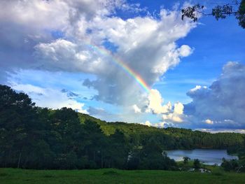 Rainbow over landscape against sky