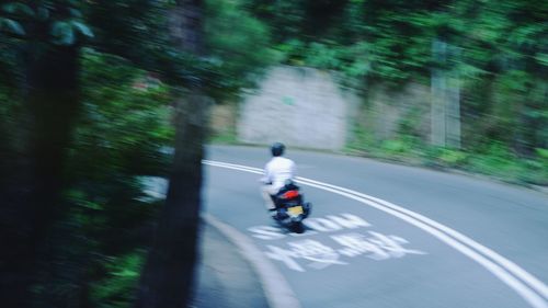 Man riding bicycle on road