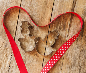 Directly above shot of pastry cutters on table with ribbon