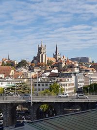 Bridge over river against buildings in city