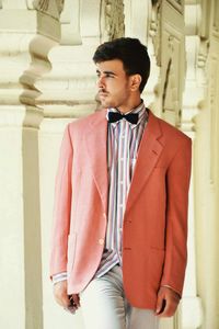 Young man in suit by columns