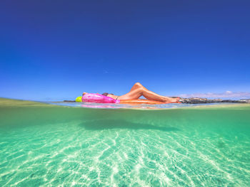 Scenic view of beach against blue sky