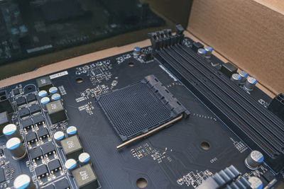 The black computer motherboard is in the package