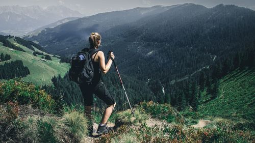 Rear view of woman standing on mountain