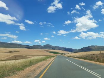 Empty road along countryside landscape