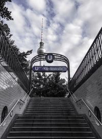 Low angle view of staircase against cloudy sky