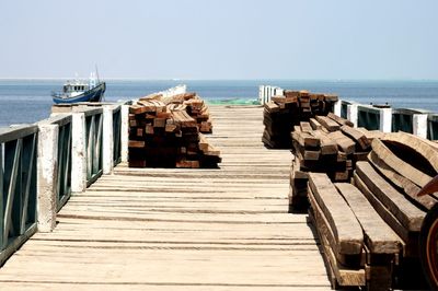 Pier amidst sea against clear sky