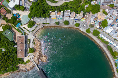 High angle view of swimming pool amidst buildings in city