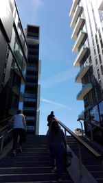 Low angle view of woman standing in city