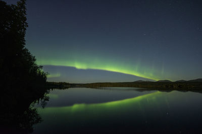 Scenic view of lake against sky at night