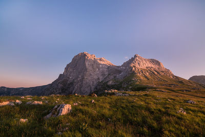 Scenic view of mountains against clear blue sky