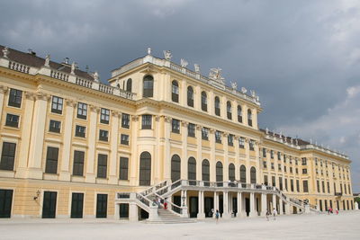 Low angle view of building against cloudy sky