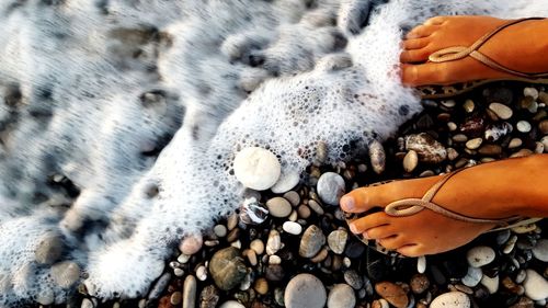 Low section of person on pebbles