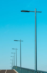 Low angle view of street light against clear blue sky