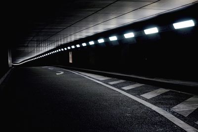 Illuminated tunnel at night