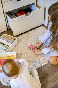 High angle view of women sitting on floor at home