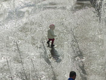 Full length of water splashing fountain