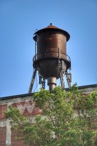 Low angle view of water tower against clear sky