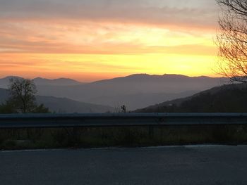 Scenic view of silhouette mountains against sky during sunset