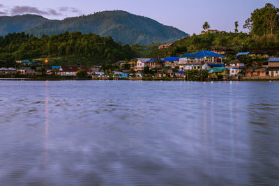 Scenic view of lake and buildings in town