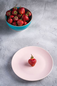 High angle view of strawberries in bowl on table