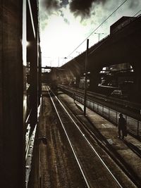 Railroad track against cloudy sky