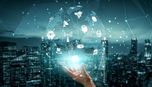 Low angle view of person touching illuminated mobile phone