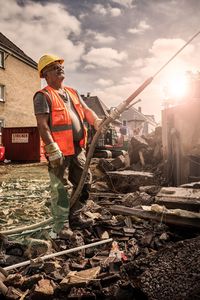 Man working at construction site against sky