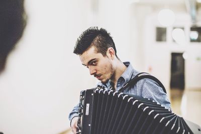 Young man playing accordion