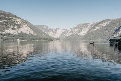 Scenic view of lake and mountains against clear sky