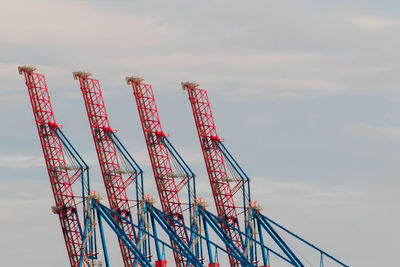 Low angle view of crane against sky