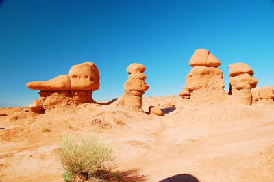 Scenic view of desert against clear blue sky