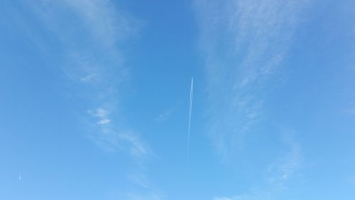 Low angle view of vapor trail in blue sky