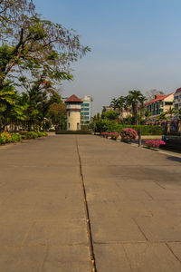 Surface level of footpath by building against sky