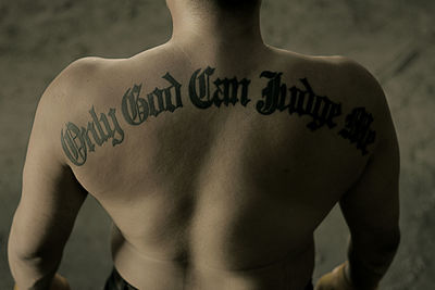 Rear view of shirtless man with tattoo text