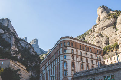 Low angle view of buildings against sky at santa maria de montserrat abbey