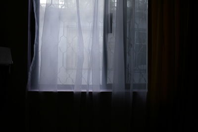 White curtain hanging on window at home