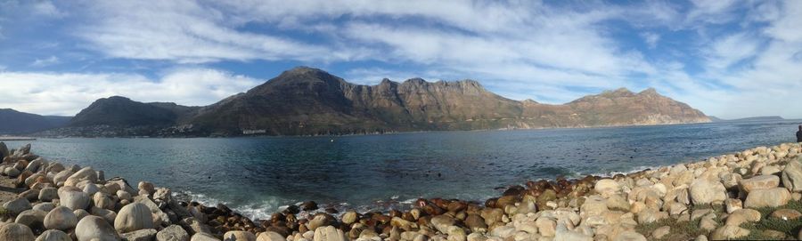 Panoramic view of sea and mountains against sky