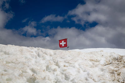 Low angle view of road sign against sky during winter