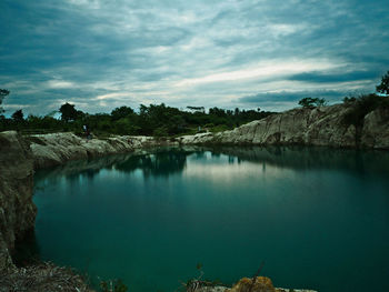Scenic view of lake against sky at sunset