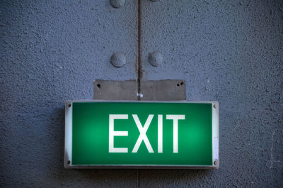 Illuminated exit sign on wall