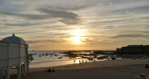 Scenic view of beach against sky during sunset