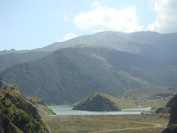 Scenic view of landscape and mountains against sky