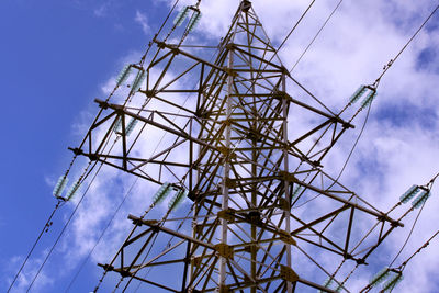 Low angle view of electricity pylon against sky