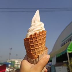 Close-up of hand holding ice cream cone